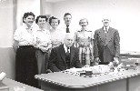 Ohnimus with clerk staff, at his desk. Clerk's office, circa 1960.