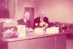 Ohnimus at desk with a legislative staffer, circa 1955 (color)