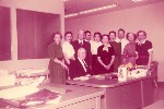 Ohnimus at desk with clerk staff, circa 1955 (color)