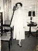 Bernice Ohnimus modeling coat at home, circa late 1950s