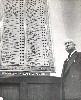 Ohnimus in front of voting display board in Chamber, approximately 1955-58