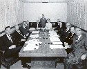 Assembly Rules Committee in 1961: Jerome Waldie, Eugene Nisbet, Jack Schrade, Chief Clerk/CAO Arthur Ohnimus, Augustus Hawkins (Chair), Assistant Sergeant-at-Arms Wes Munroe, Rules Committee Secretary Peggy James, Fiscal Officer John Saylor, Tom Bane, Har