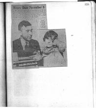 News clipping shows a picture of Arthur Ohnimus teaching Rita Wallace how to use a sample voting machine.