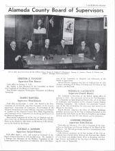 Group of men sitting at a table facing towards the camera