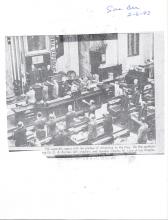 assembly session opening with a pledge of allegiance. There is a description at the bottom of the image it reads: The assembly opens with the pledge of allegiance to the flag.