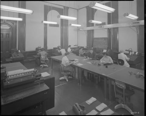 Rare image showing Controller’s office in the Capitol building in 1952. Workers are seen processing checks and using 1950s era office equipment.